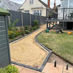 a backyard with a small garden and a deck